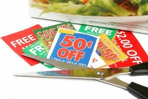 clipping coupons to save money at the grocery store